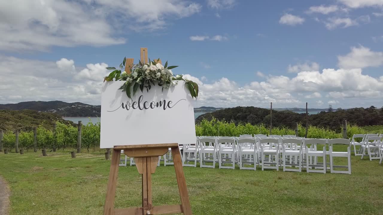 Aerial shot of a wedding set up with a bouquet and many chairs in a winery.