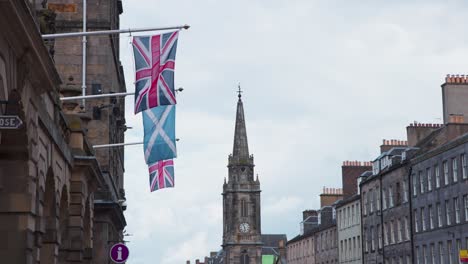 british and scottish flags on facade flagpoles, royal mile, edinburgh