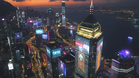 aerial birds eye shot of lighting skyscraper buildings in hong kong city with breaking news hologram motion graphic at night - connecting futuristic concept with digital diagram