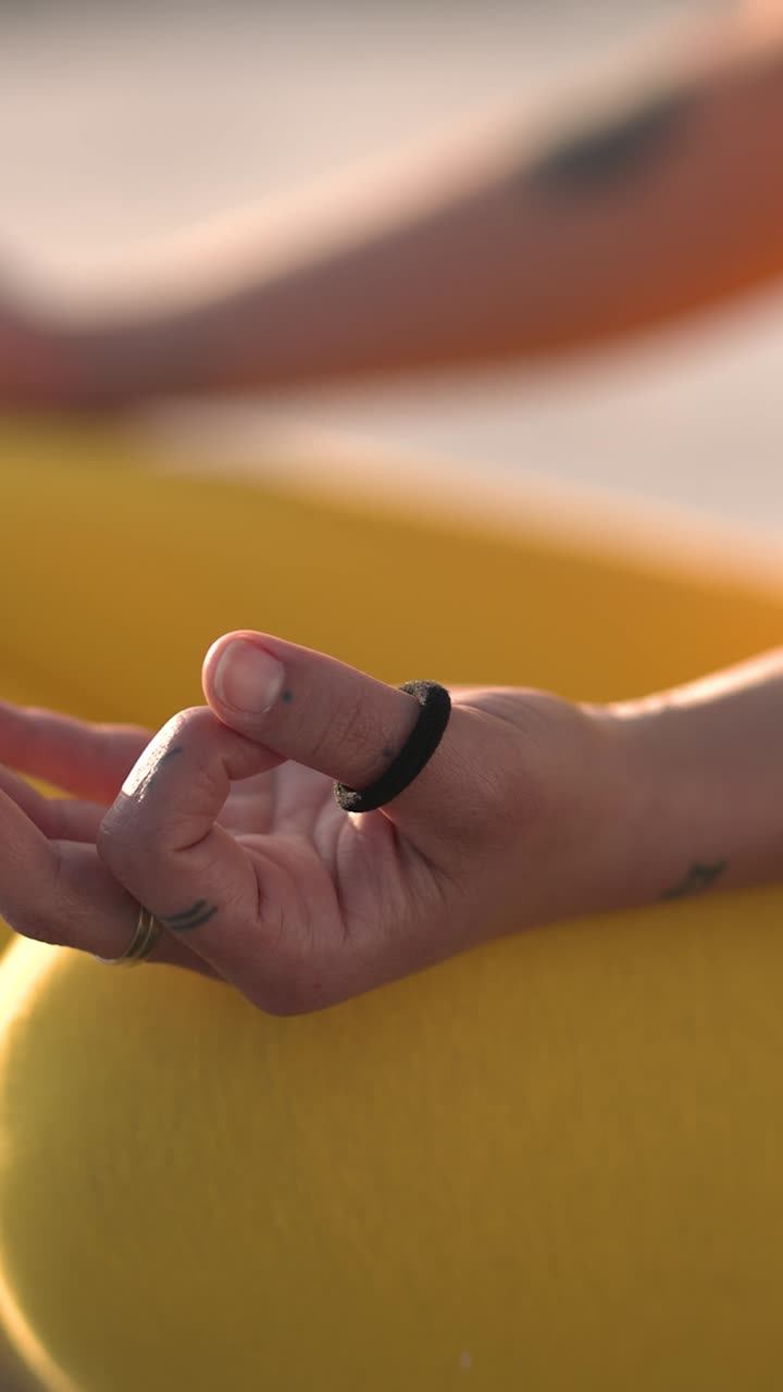 Crop woman hand in yoga mudra at beach during daytime