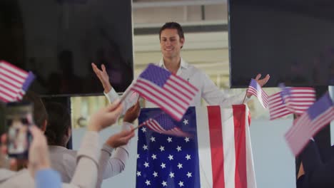 Victorious-male-speaker-and-audience-at-political-convention