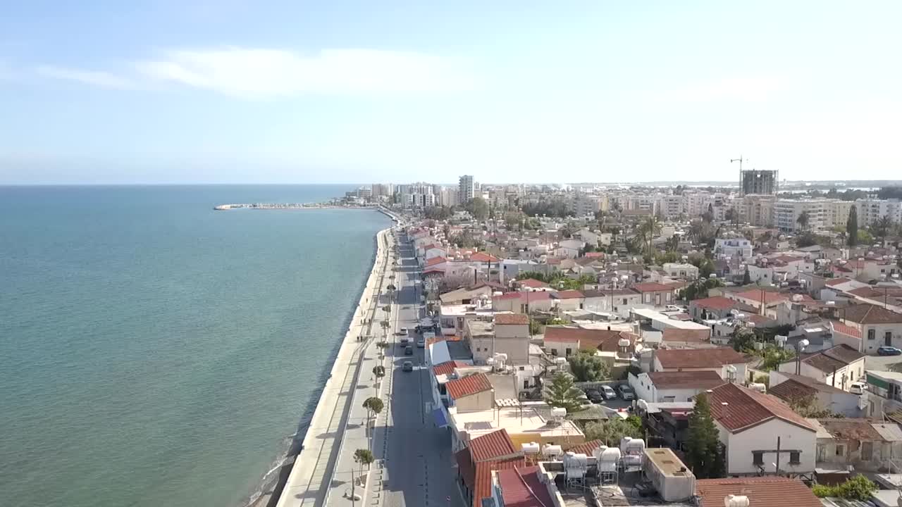 toma inclinada hacia arriba que revela la calle mackenzie ubicada en un impresionante mar claro, ciudad de larnaca, chipre.