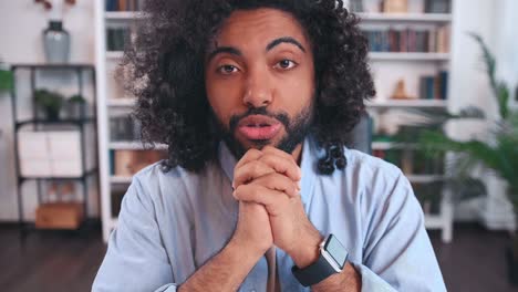 confident arabian man something is telling and gesticulating screen view