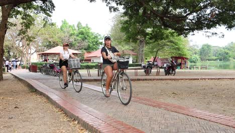 people cycling through a scenic park pathway