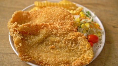 fish and chips with mini salad on white plate