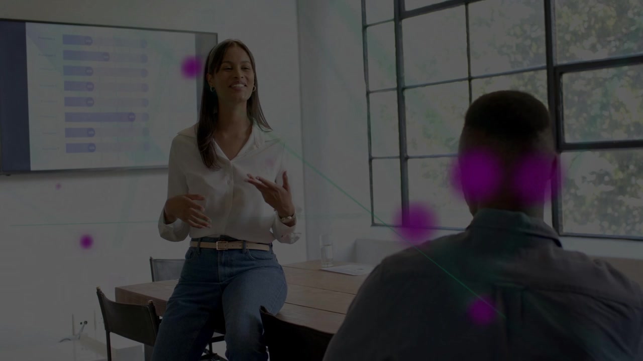 Woman presenting on gesture, pink dots appearing, grouping near man shifting to screen showing data