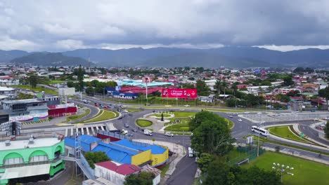 a newly built roundabout, with cars going slowly, in the residential area of san jose, costa rica