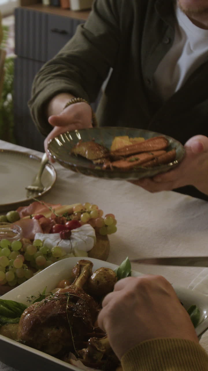 People passing food around a dinner table