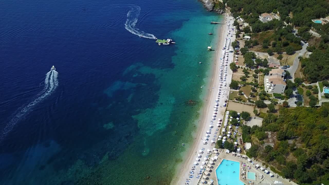 Aerial view of the coastline, beach, hotels and boats at the sea in Greece