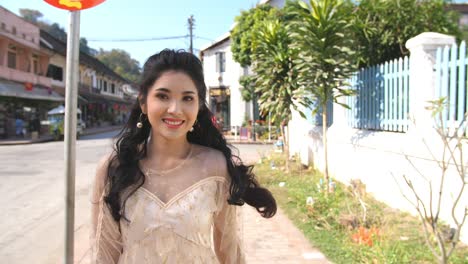 young woman walking through a charming town