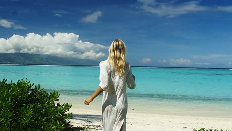 girl running towards a beautiful beach in french polynesia. slow motion