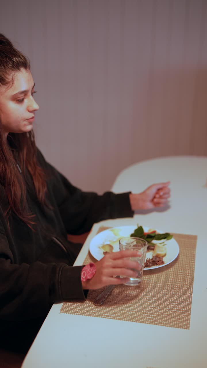 Woman eating dinner at home