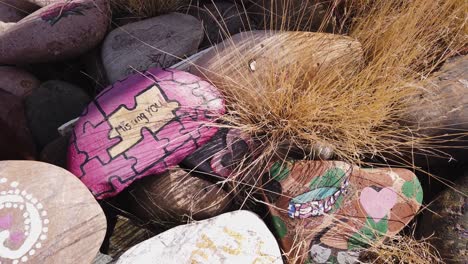 arc on a pile of decorative rocks in the desert with painted messages