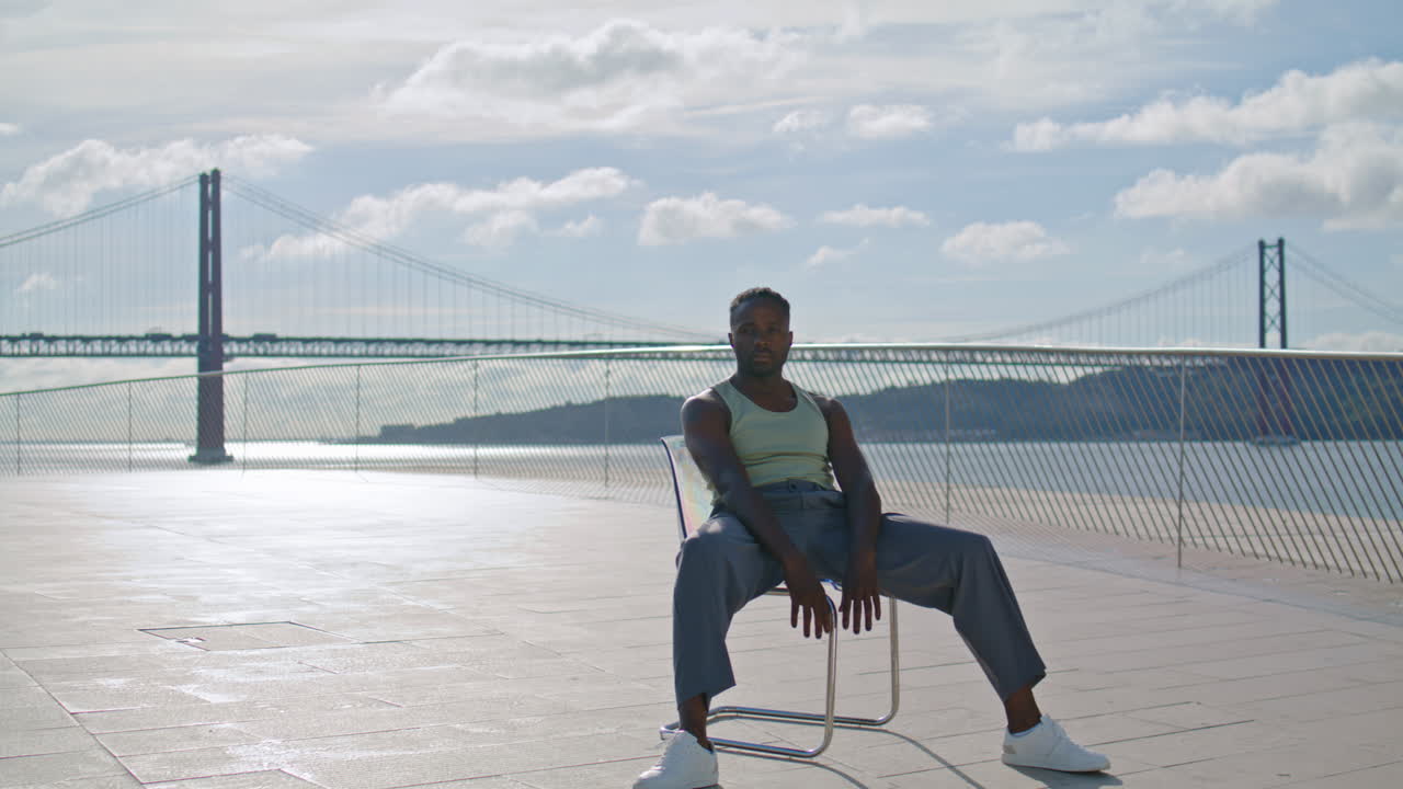bailarín moderno sentado en una silla en el fondo del mar vertical. coreógrafo posando