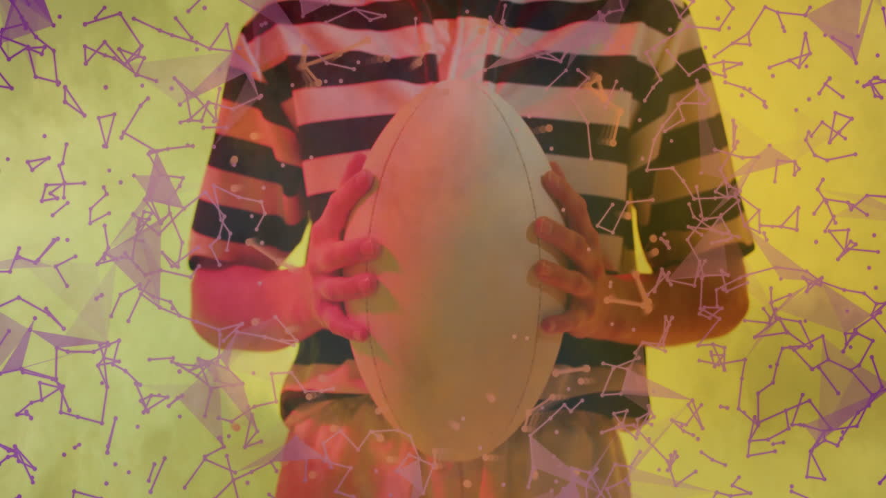 Holding rugby ball, person with abstract geometric animation overlay on screen