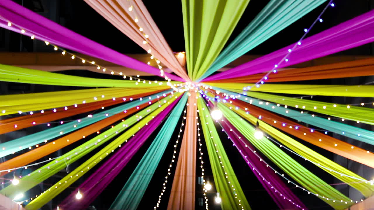 Vibrant Navratri festival decoration with colorful drapes and string lights at night. Perfect for festival, celebration, culture and Indian tradition themes