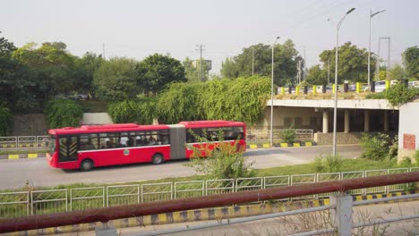 metro bus emerges from underpass: a scenic cityscape with lush greenery and modern infrastructure