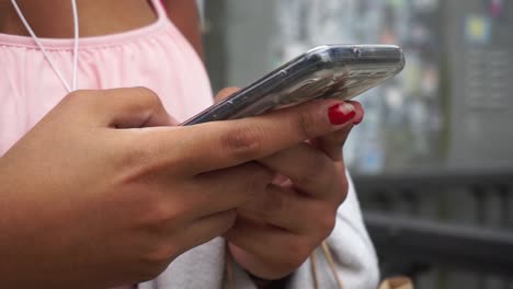 Manos-Femeninas-Usando-Teléfono-Celular-En-La-Calle,-Cerrar