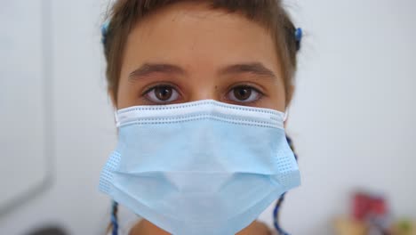 Young-Girl-Putting-On-Face-Mask-Close-Up