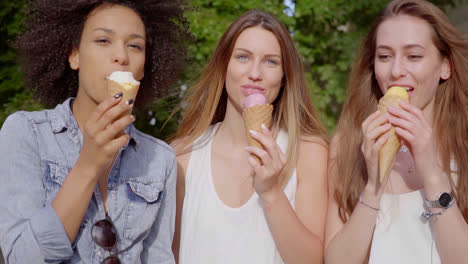 cheerful women eating tasty ice cream