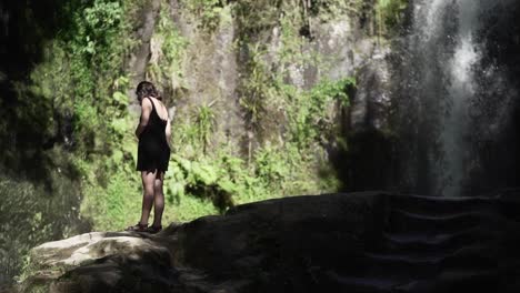 Woman by a waterfall