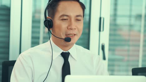 businessman wearing headset working actively in office