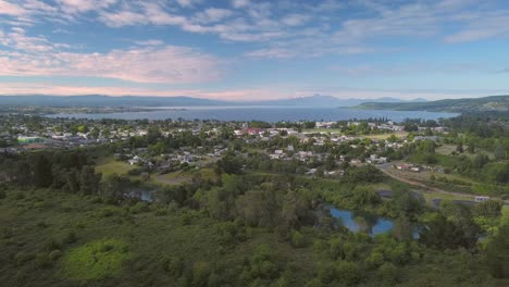 Aerial-tracking-shot-of-Taupo,-New-Zealand-with-Mount-Ruapehu