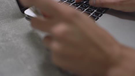 hands-of-cardholder-holding-credit-card-making-e-bank-online-payment.-Woman-consumer-paying-for-purchase-in-web-store-using-laptop-technology.-Ecommerce-website-payments-concept.-Close-up-view