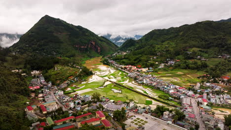 aerial reveals a man on don cao fortress viewpoint in dong van valley, vietnam. pullback shot