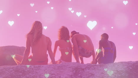 group of friends sitting on rocks with heart animation over pink background