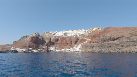 the village of thira on santorini from a ferry boat in slow motion