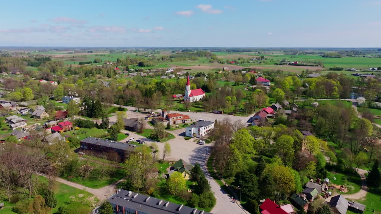 Peaceful aerial view of small village Rucava Latvia with fields church and trees