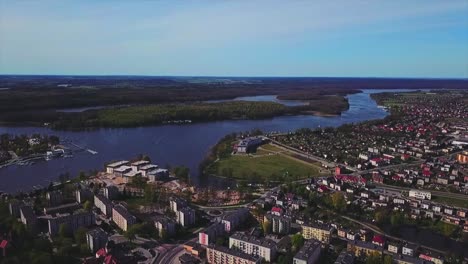 drone flying above a city, towards a river