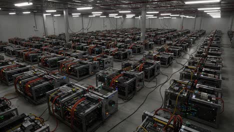aerial view of an extensive cryptocurrency mining facility filled with rig units and complex wiring systems operated under bright industrial lighting