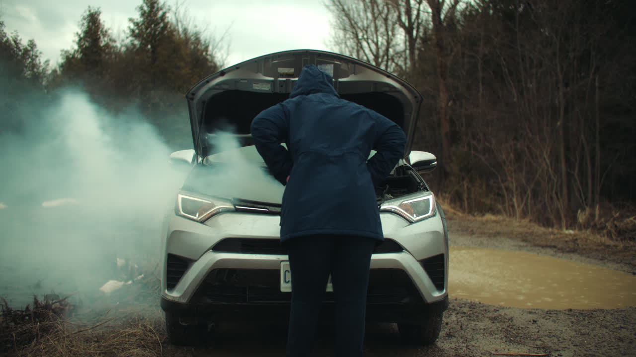 Frustrated Woman Inspecting Smoke Coming from Broken Car Engine. Vehicle Breakdown Motor Overheating Auto Failure. Worried Young Girl Stranded on Road Accident Emergency Repairs Trouble Slow Motion 4k