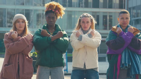 Portrait-Of-Female-Protestors-With-Arms-Crossed-On-Demonstration-March