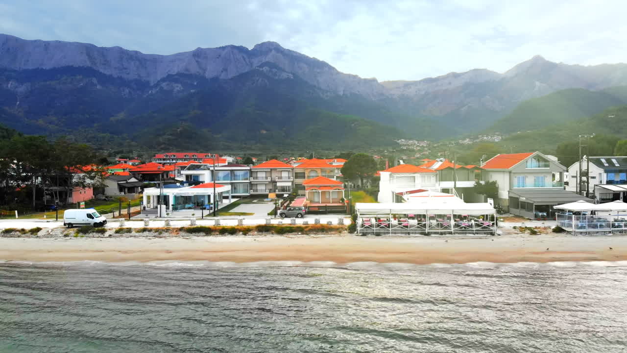 Aerial view of Aegean sea coast of Thassos, buildings, beach, hills on the background, Greece