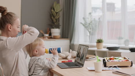 businesswoman having online conference and babysitting