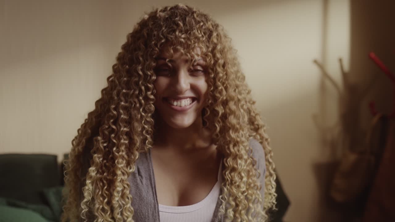 Portrait of a Happy Young Woman with Curly Hair