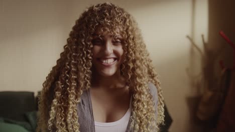 portrait of a happy young woman with curly hair