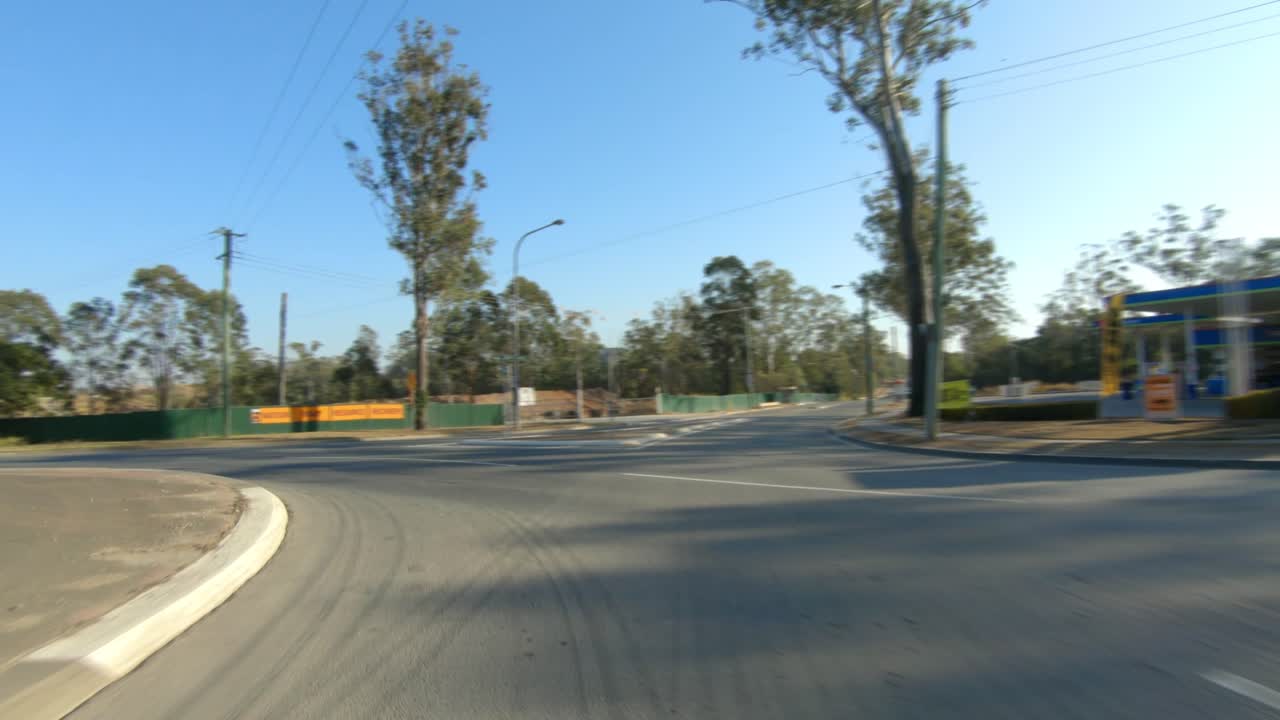 Rear facing driving point of view POV of driving round a roundabout on quiet Australian country roads - ideal for interior car scene green screen replacement