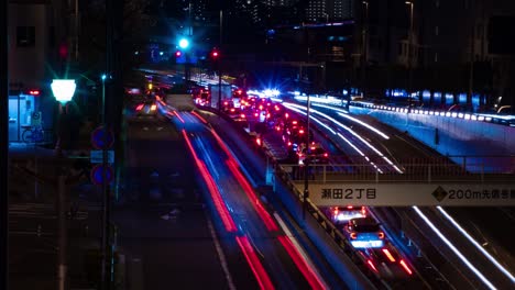 a night timelapse of the traffic jam at the city street in tokyo long shot