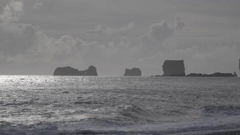 Panorama-of-Dyrholaey-from-Reynisfjara,-a-famous-black-sand-beach-on-the-south-coast-of-Iceland