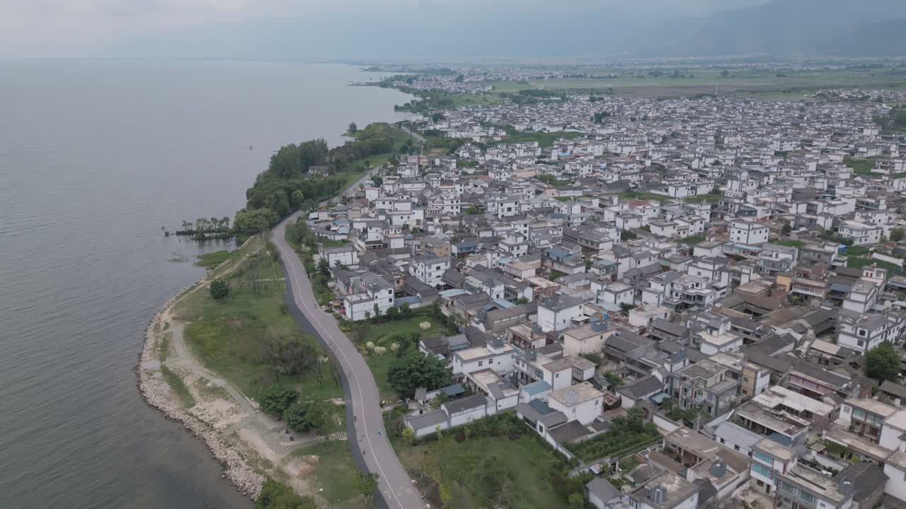 Aerial footage of a small village settlement next to the Haishe Ecological Park in Dali, Yunnan Province in China