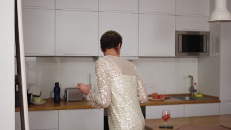 a man in a dress standing in front the mirror, doing makeup