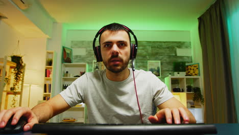 pov of young man with headphones playing games