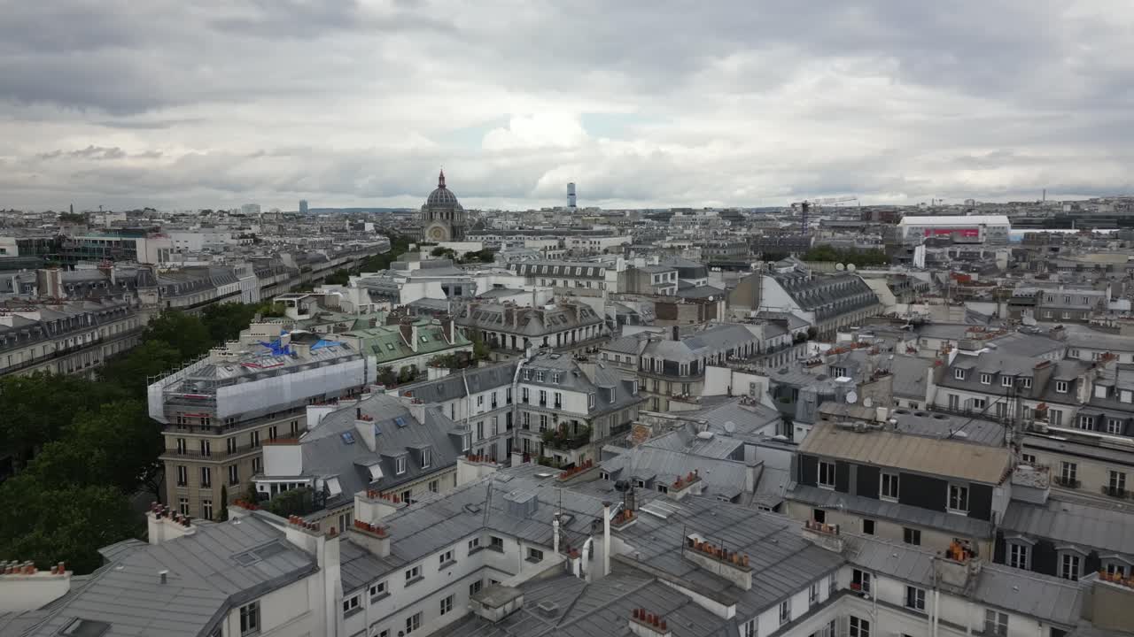 Aerial View of Parisian Rooftops under a Cloudy Sky