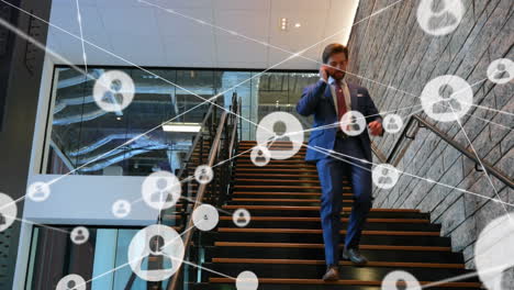 network of profile icons against caucasian businessman climbing down the stairs at office