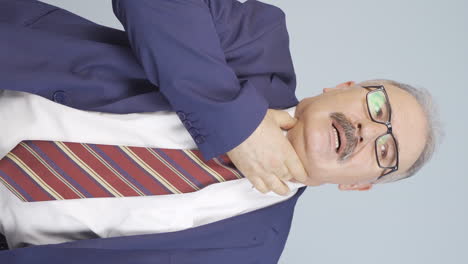 vertical video of old businessman experiencing shortness of breath.