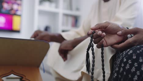 african muslim couple at home in ramadan reading quran holly islam book